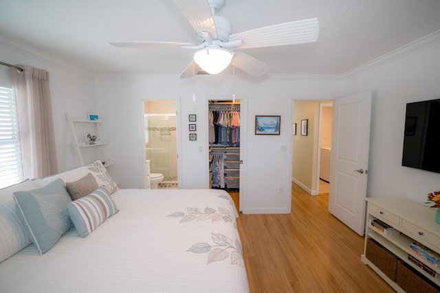 bedroom with ensuite bath, ceiling fan, ornamental molding, light hardwood / wood-style floors, and a closet