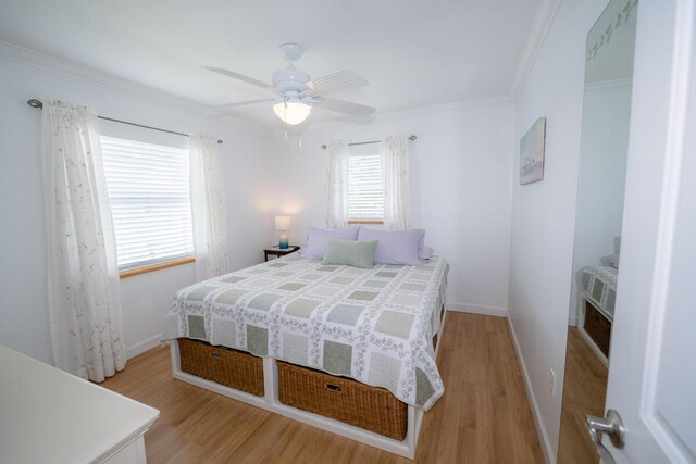 bedroom with crown molding, ceiling fan, and light wood-type flooring