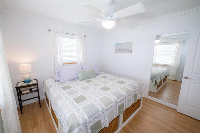 bedroom featuring ornamental molding, ceiling fan, and light hardwood / wood-style floors