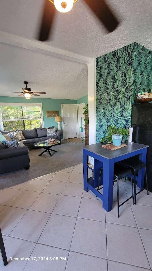 tiled dining room featuring ceiling fan and a textured ceiling