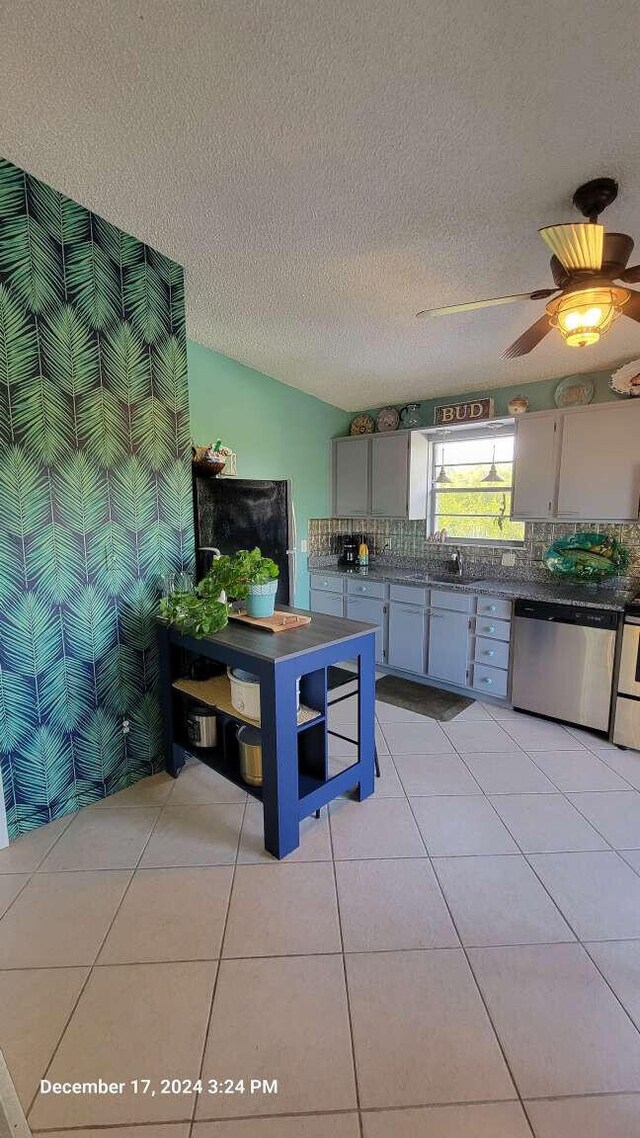 kitchen featuring gray cabinetry, light tile patterned floors, ceiling fan, and appliances with stainless steel finishes