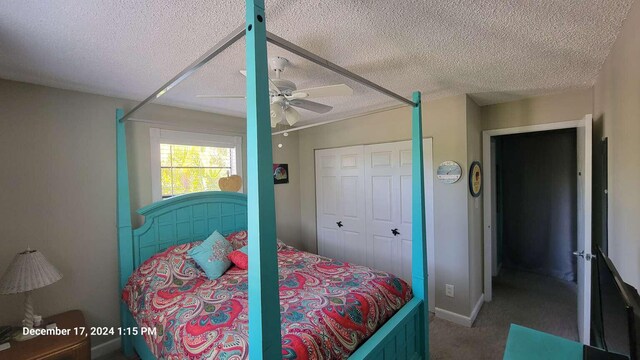 carpeted bedroom with a textured ceiling, ceiling fan, and a closet