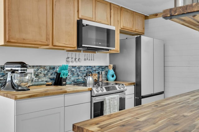 kitchen featuring wood counters, white cabinetry, stainless steel electric stove, and wood walls