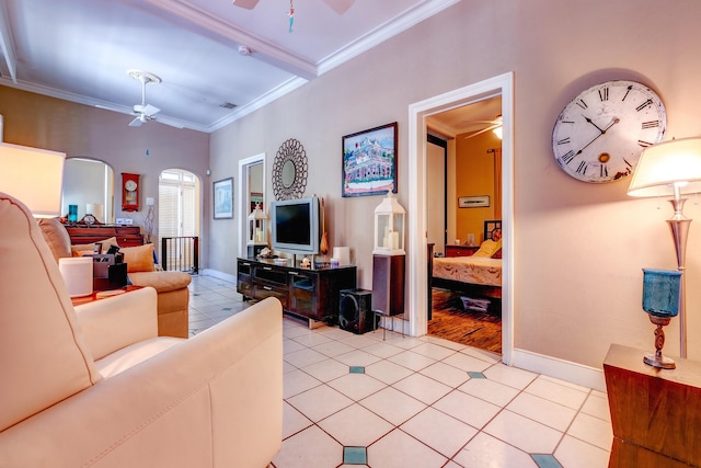 living room with crown molding, light tile patterned floors, and ceiling fan