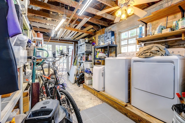 basement with ceiling fan, independent washer and dryer, and a healthy amount of sunlight