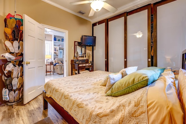 bedroom with crown molding and hardwood / wood-style flooring