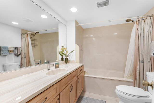 full bathroom with shower / tub combo with curtain, vanity, tile patterned floors, and toilet