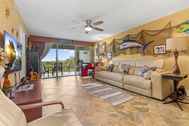 living room with a textured ceiling and ceiling fan