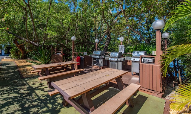 wooden terrace featuring area for grilling and a grill