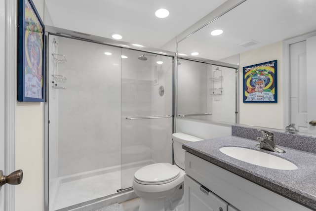 bathroom featuring vanity, toilet, and walk in shower