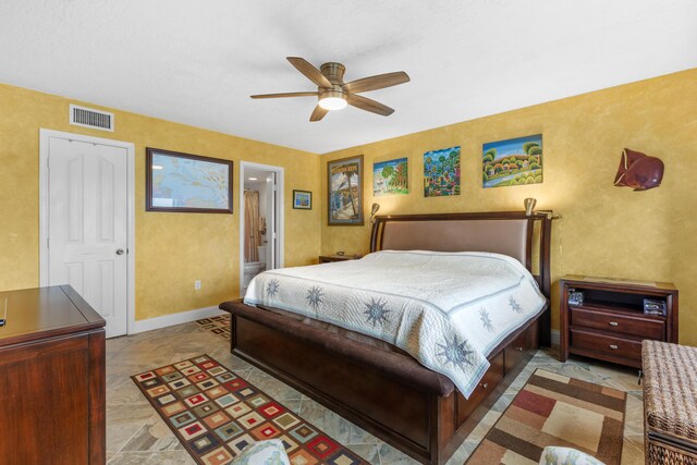 bedroom featuring ensuite bathroom and ceiling fan