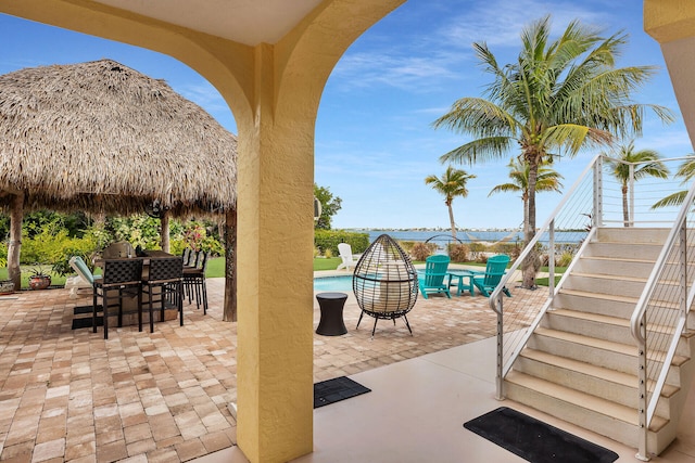 view of patio featuring a gazebo and a water view