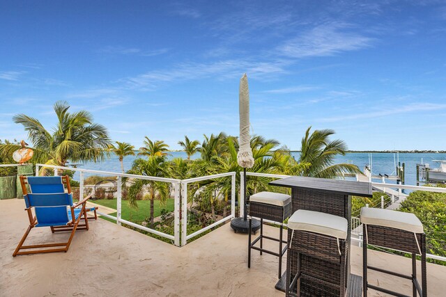 view of patio / terrace featuring a balcony and a water view