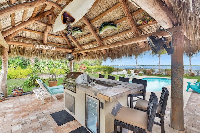 view of patio / terrace with an outdoor bar, a gazebo, area for grilling, grilling area, and beverage cooler