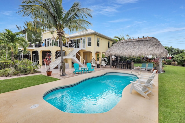 view of pool featuring a gazebo, a patio area, a lawn, and exterior bar