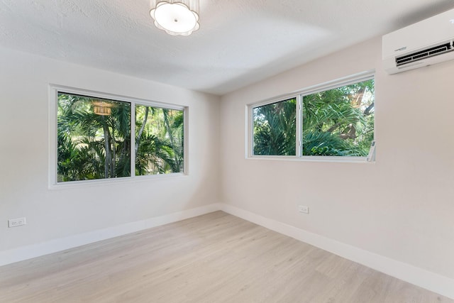 82260 Overseas Hwy, Islamorada, FL 33036 - unfurnished room with a wall mounted air conditioner and wood finished floors