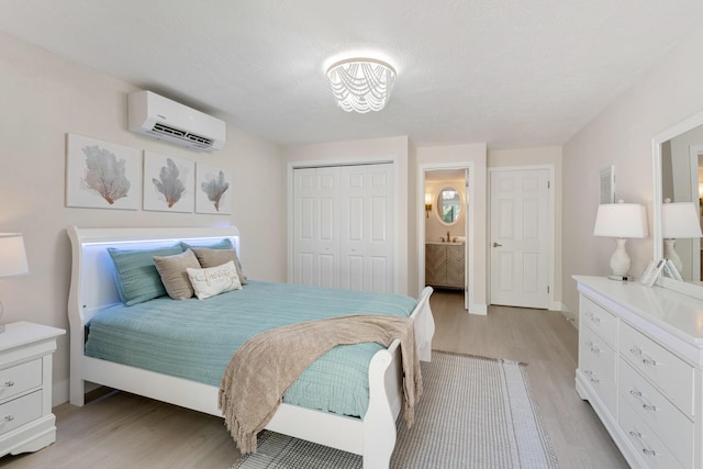 82260 Overseas Hwy, Islamorada, FL 33036 - bedroom featuring a wall mounted air conditioner, light wood-type flooring, and a closet