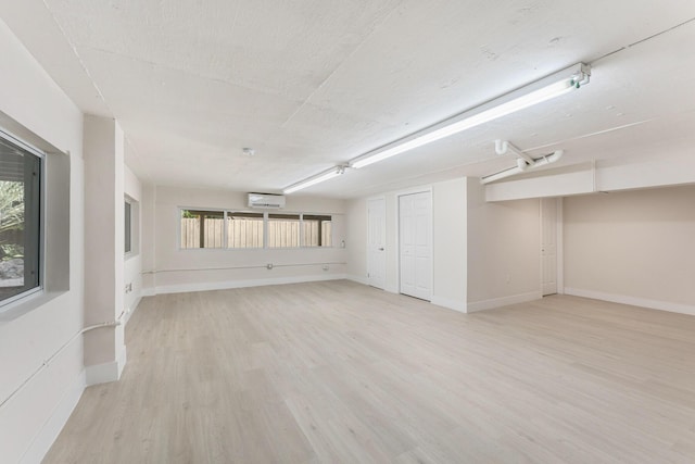 82260 Overseas Hwy, Islamorada, FL 33036 - unfurnished room featuring a wall unit AC and light wood-style floors