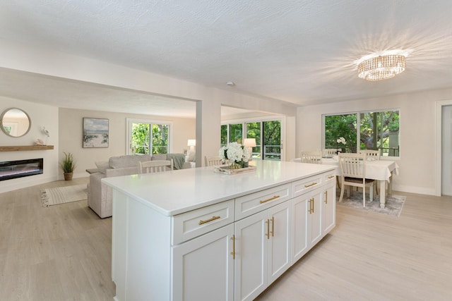 82260 Overseas Hwy, Islamorada, FL 33036 - kitchen featuring open floor plan, light wood finished floors, a kitchen island, and light countertops
