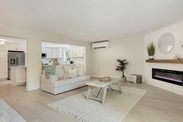 82260 Overseas Hwy, Islamorada, FL 33036 - living area with light wood finished floors, a wall unit AC, and a glass covered fireplace