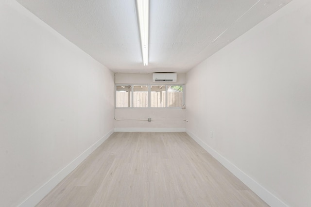 82260 Overseas Hwy, Islamorada, FL 33036 - unfurnished room featuring light wood-type flooring and an AC wall unit