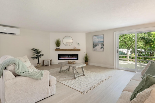 82260 Overseas Hwy, Islamorada, FL 33036 - living area with an AC wall unit, wood finished floors, and a glass covered fireplace