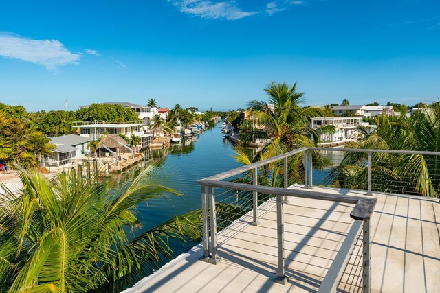 view of dock featuring a balcony and a water view