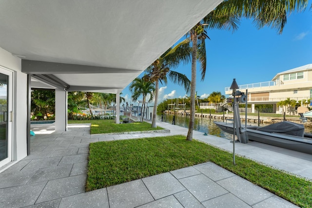 view of yard with a water view and a dock