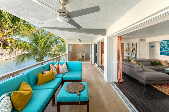 exterior space featuring ceiling fan and an outdoor hangout area