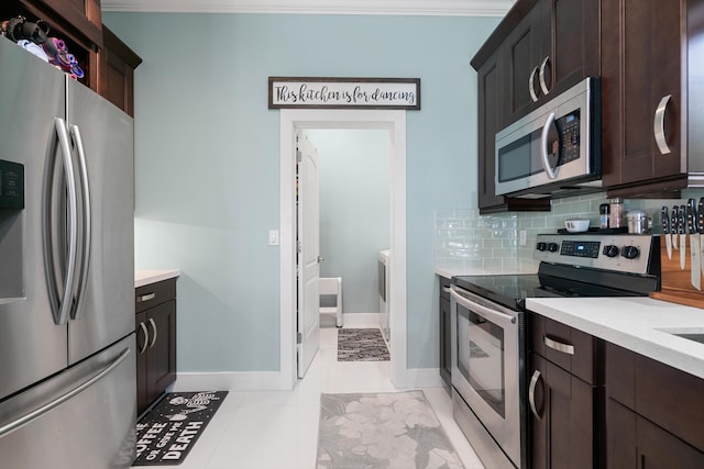 kitchen featuring tasteful backsplash, appliances with stainless steel finishes, dark brown cabinetry, and light countertops