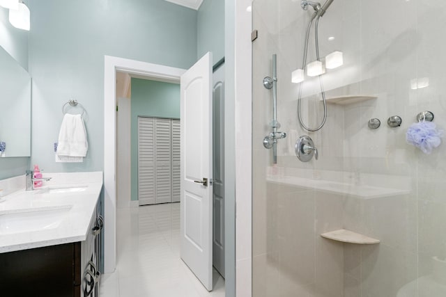 bathroom with a sink, a stall shower, and double vanity