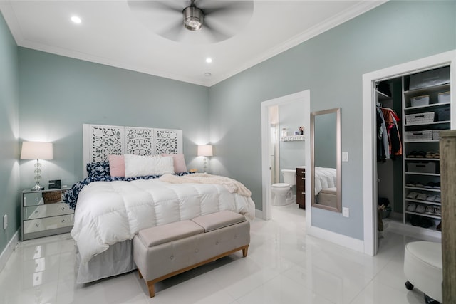 bedroom with a spacious closet, baseboards, a closet, and ornamental molding