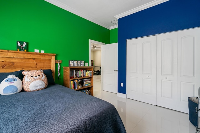 tiled bedroom featuring a closet, ornamental molding, and an accent wall