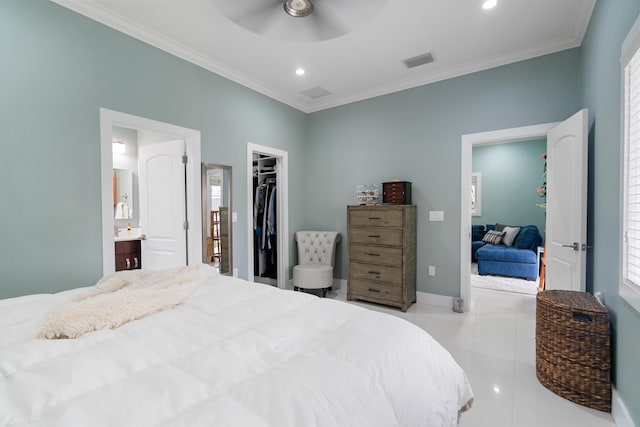 tiled bedroom with visible vents, baseboards, a spacious closet, and crown molding