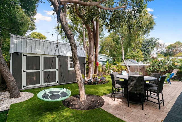 view of patio with a storage shed, an outdoor structure, and fence