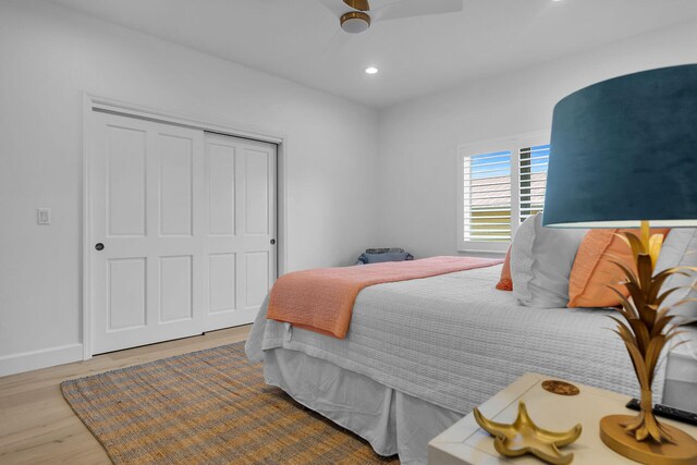 bedroom featuring wood-type flooring, a closet, and ceiling fan