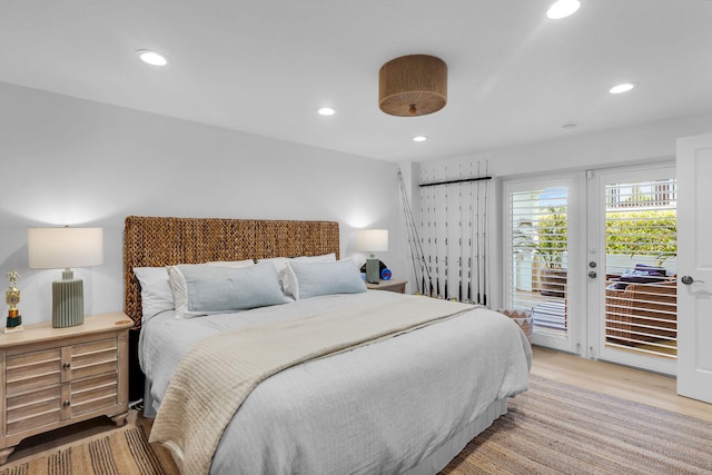 bedroom with access to exterior, light wood-type flooring, and french doors