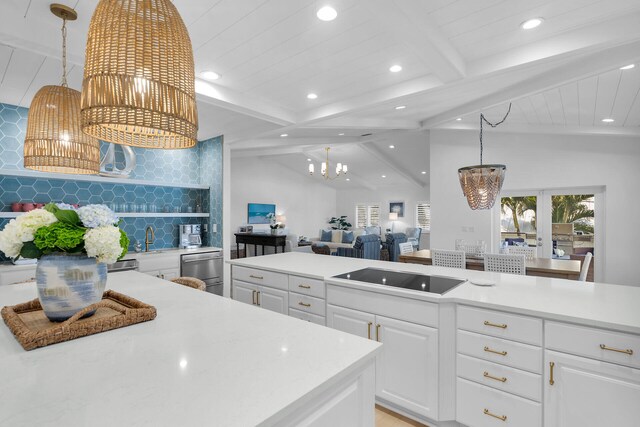 kitchen featuring black electric cooktop, white cabinetry, tasteful backsplash, and lofted ceiling with beams