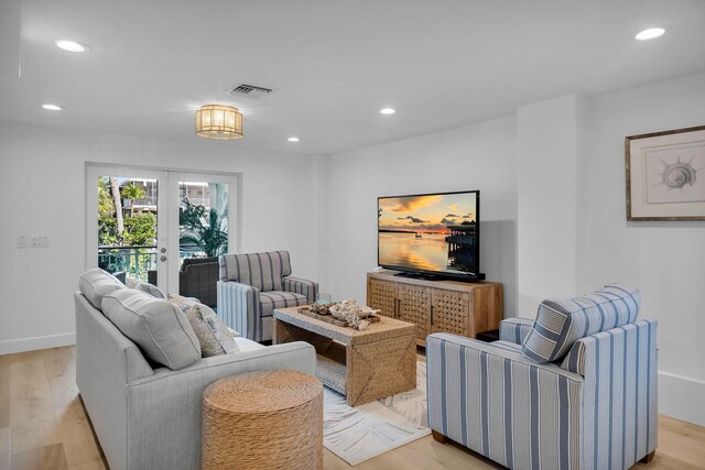 living room featuring light hardwood / wood-style floors and french doors