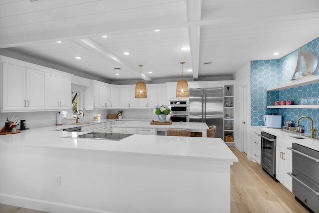 kitchen with wine cooler, white cabinetry, hanging light fixtures, beamed ceiling, and stainless steel appliances