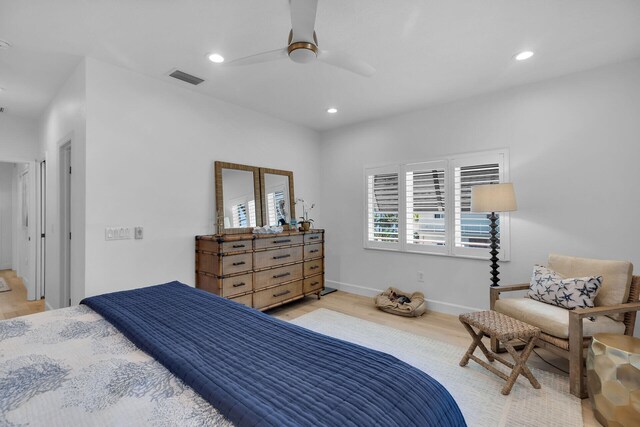 bedroom with ceiling fan and light hardwood / wood-style floors