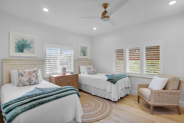 bedroom featuring multiple windows, light hardwood / wood-style flooring, and ceiling fan