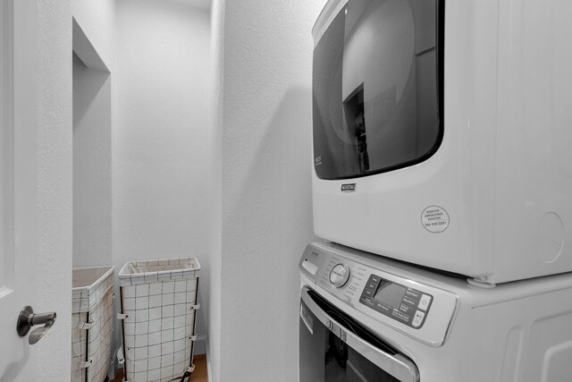 laundry room with stacked washer and clothes dryer