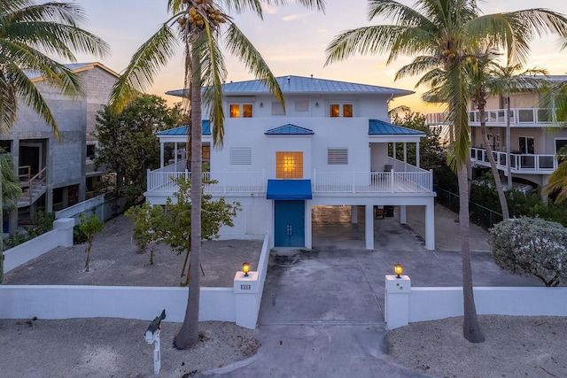 view of front of house featuring a balcony and a carport