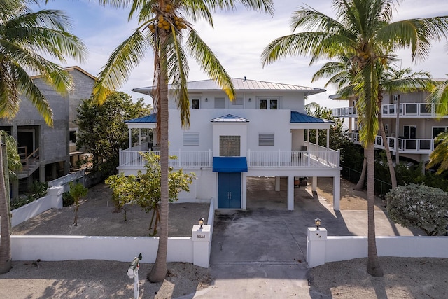 view of front of home with a balcony and a carport