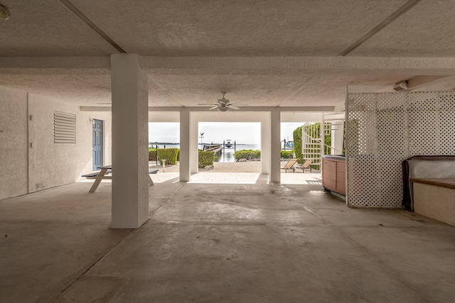 garage featuring ceiling fan and a patio area