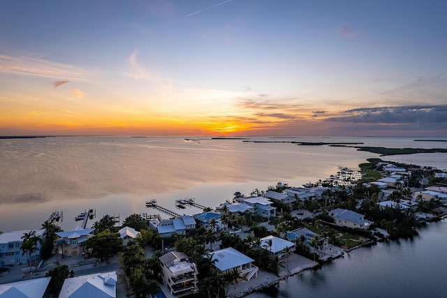 aerial view at dusk with a water view