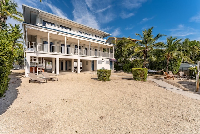 back of house with a balcony and a patio area