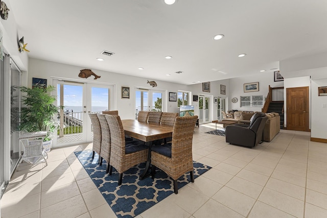 dining area with french doors and light tile patterned floors