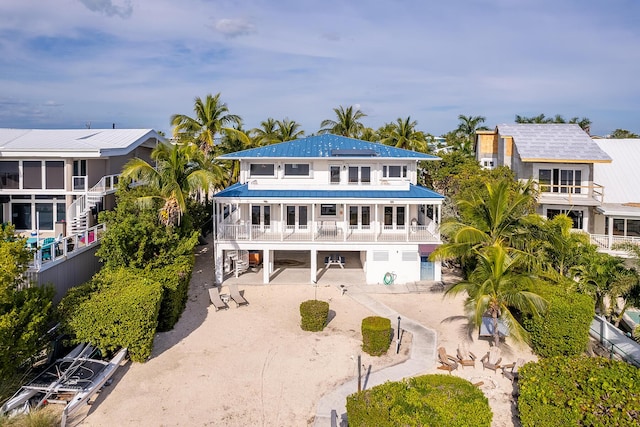 back of house with a balcony and a carport